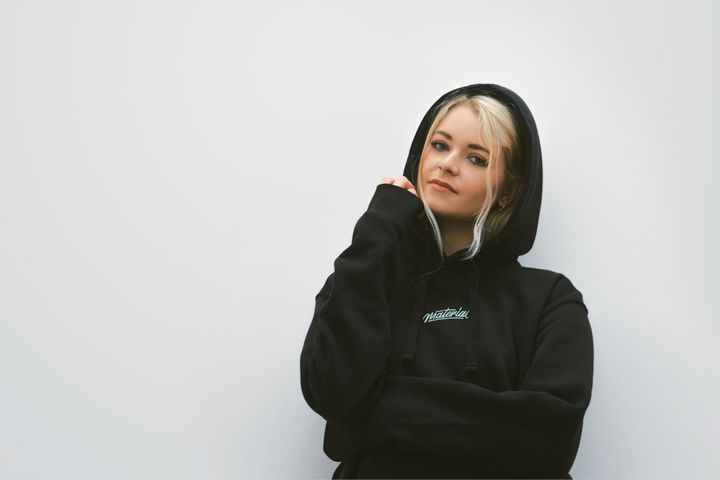 Photo of Abbie wearing a Material Studios hoodie