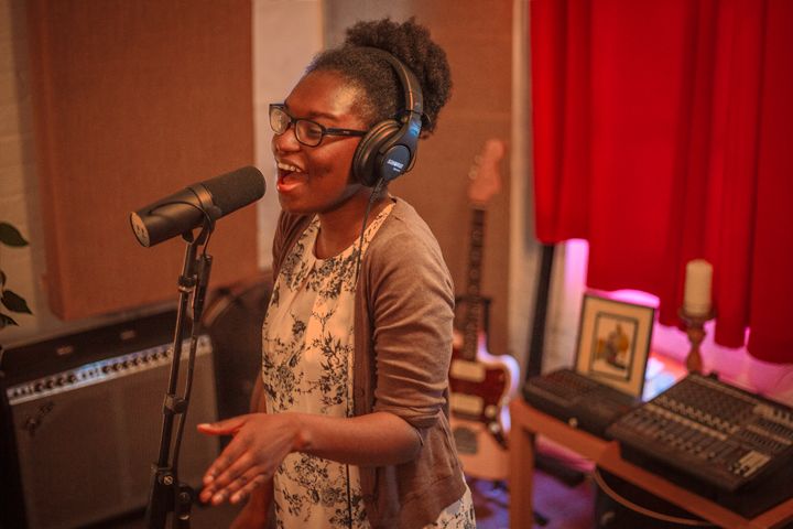 Attractive female singing into Shure SM7B at Material Studios